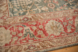Distressed, low-pile texture on the cherry red border and green field of a vintage Tabriz.