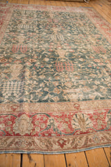 Vintage distressed Tabriz carpet showing the unidirectional tree of life design from a corner perspective.