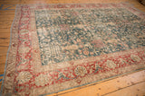 An angled view showcasing the full expanse and decorative wear of the vintage Persian Tabriz carpet.