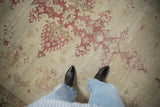 Distressed low pile and raspberry palmette details on a vintage Indian Amritsar carpet.