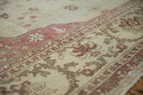 Angled close-up of the distressed Amritsar carpet's mostly even wear to the knot heads.