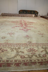 Low-angle view along the central axis of a distressed Amritsar rug showing the worn pile texture.