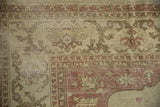 Time-softened pile and visible foundation on the corner of a distressed Amritsar carpet.