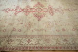 Low-pile texture with visible knot heads on an ivory and raspberry vintage Amritsar carpet.