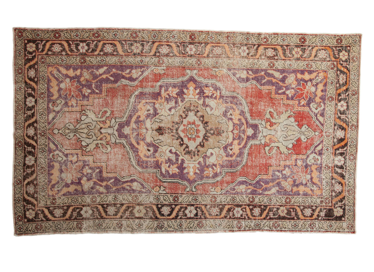 Vintage Distressed Oushak carpet with scalloped medallion, floral vines, time-softened violet, red, ivory.