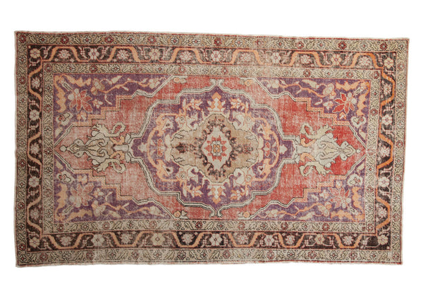 Vintage Distressed Oushak carpet with scalloped medallion, floral vines, time-softened violet, red, ivory.