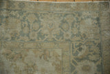 Kayseri rug corner with dusty gold, sea foam green geometric vinery and floral tendrils.