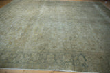 Vintage Kayseri carpet border with muted green geometric motifs and low pile floral field.