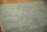 Vintage Kayseri carpet's geometric vinery and tendrils in oxidized green, ivory, dusty gold.