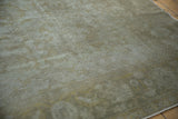 Muted pale dusty green, ivory, and dusty gold tones with subtle geometric vinery.