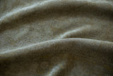 Hand-knotted Kayseri carpet pile detail, showing subtle pale green and dusty gold motifs.