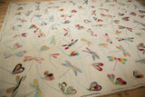 Detailed view of varied colorful dragonfly motifs on a light beige pictorial Kilim rug.