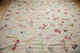 Vibrant dragonfly motifs scattered across the plain woven kilim's beige background.