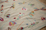 Colorful hand woven dragonflies featuring raspberry, mint, and blue on a plain weave Kilim.