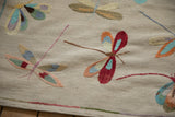 Detail of Pakistani mixed weave pictorial Kilim with colorful embroidered dragonflies and selvage.