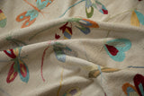 Textured beige-gray pictorial kilim with colorful embroidered dragonfly motifs.