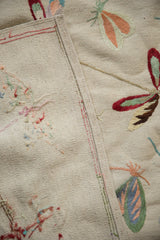 Pakistani Mixed Weave Pictorial Kilim rug's beige texture, side selvage, and embroidered multicolor dragonfly detail.