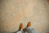 A personal perspective of the vintage Birjand carpet's soft, worn texture and muted colors.