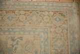 Detail of the book cover spandrel and distressed floral border on a vintage Birjand rug.