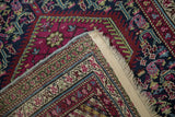 Detail of Antique Karabagh runner's fringed end, showing intact selvage and intricate plum and navy border.