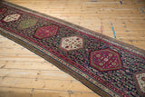 Antique Karabagh runner: plum hexagonal medallion, navy field with delicate vines, and intricate borders.