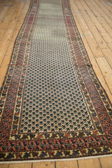 Hand-knotted lattice of minor blossoms, geometric serpent border in dusty teal and red.