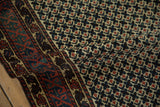 Geometric serpent stylized main border and lattice field pattern on a vintage Afghani runner, showing madder red, teal, and ivory.