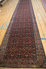 Full length perspective view of the vintage Persian Engelas runner showing its allover Herati design.