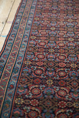 Intricate Herati pattern and meandering vine border on a vintage Persian Engelas runner.