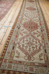 Antique distressed Serab runner showing geometric pawn border and muted plant motifs.
