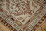 Antique Serab rug corner detail: reciprocating pawn border, finned plants, time-softened beige, chestnut tones.