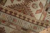 Distressed texture and reciprocating pawn motif on the border of the antique Serab runner.