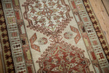 Distressed Serab runner showing beige field, potted plant motifs, and pawn design border.