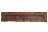 Vintage Persian Qashqai runner with repeating plant motifs on a chocolate brown field and saffron gold border.