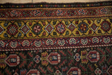 Unusual saffron gold main border on a vintage Qashqai rug with a chocolate brown field.