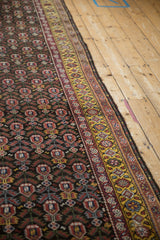 Close-up of the vintage Qashqai runner's intact side cord selvage and saffron gold border.