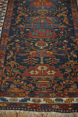 Vintage Northwest Persian runner fringe, serrated leaf border, and blue field with potted plants.