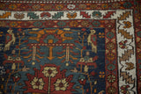 Corner of vintage Persian rug runner with ivory serrated leaf border, navy field, birds, vines.