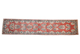 Distressed vintage Arak runner, faded cherry red field with ivory and navy floral sprays.