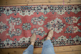 Abrashed cherry red vintage Arak rug detail showing distressed navy, ivory, mint floral motifs.