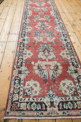 Faded cherry red field of the vintage Arak rug, showing distressed floral motifs.