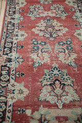 Distressed Arak runner: faded cherry red ground, worn pile, navy, ivory floral patterns.