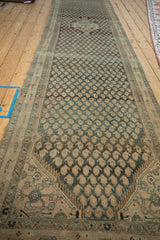 Distressed Malayer runner's border, sharp serrated outline, and dusty teal field abrashes.