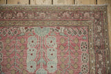 Vintage Distressed Dargezine rug corner, showing machine bound side, fringe, and wear to pattern.