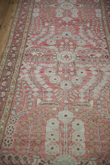 Distressed pale raspberry red Dargezine runner with thousand flower stylized motifs.