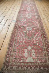 Distressed vintage Dargezine runner detail: soft raspberry red field, pale blue, beige stylized flowers.