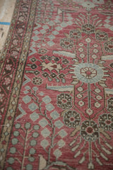 Distressed pale raspberry red Dargezine runner showing pale powder blue blossom motifs.