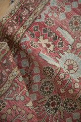 Vintage Dargezine rug detail showing distressed texture, visible knot heads, and pale red hues.