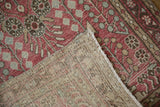 Vintage Dargezine runner showing distressed raspberry red pile, floral motifs, and woven foundation.