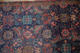 Herati pattern detail on vintage Tabriz rug in navy, red, and sky blue.